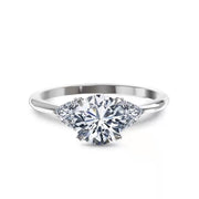 Round cut lab grown diamond three stone engagement ring with prong setting, symbolizing past, present, and future love