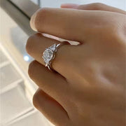 Round cut lab grown diamond three stone engagement ring with prong setting, symbolizing past, present, and future love