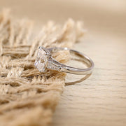 Radiant cut lab grown diamond three stone engagement ring with side stones in elegant prong setting on polished gold band