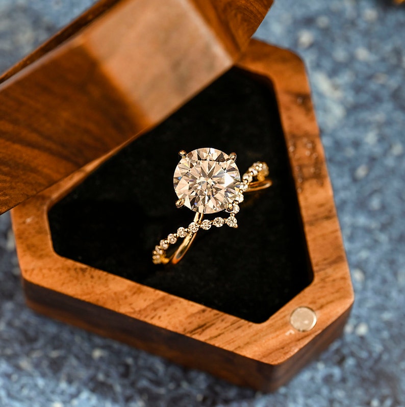 Round cut lab grown diamond unique engagement ring in a contemporary setting with elegant design on polished gold band