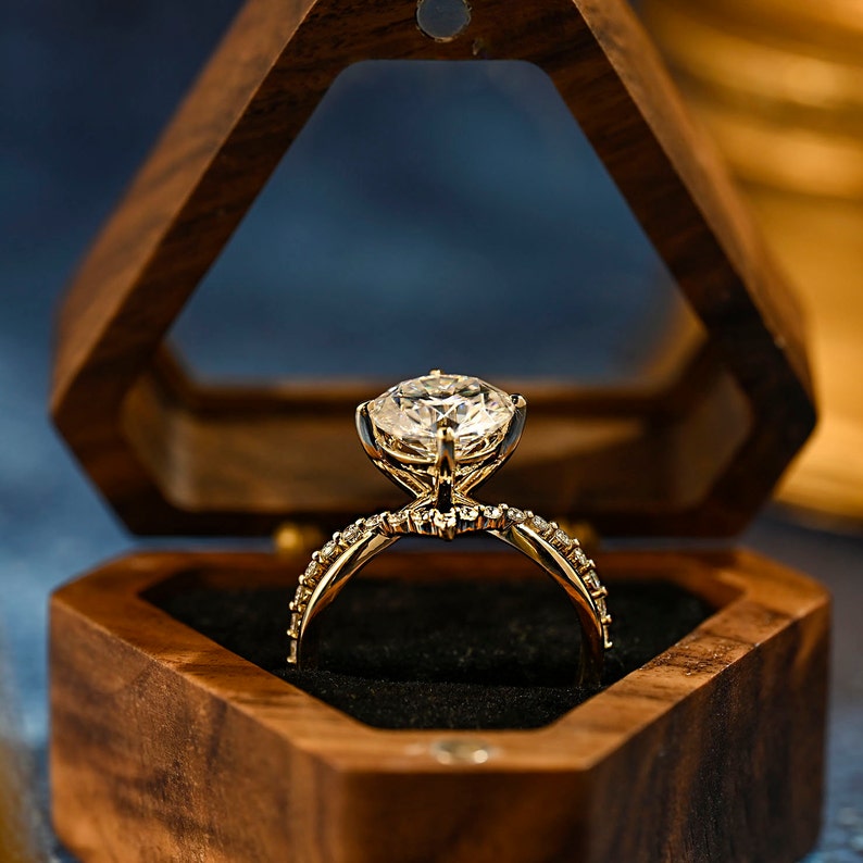 Round cut lab grown diamond unique engagement ring in a contemporary setting with elegant design on polished gold band