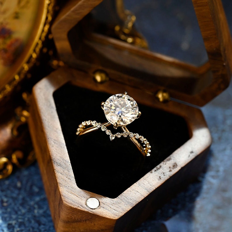 Round cut lab grown diamond unique engagement ring in a contemporary setting with elegant design on polished gold band