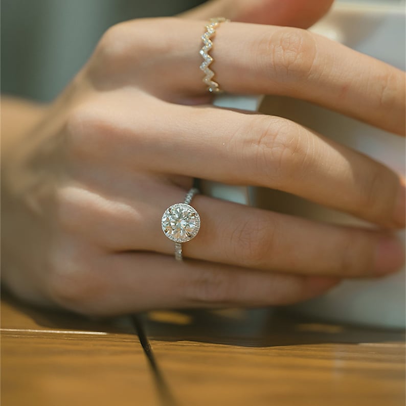 Round cut lab grown diamond halo pavé engagement ring with side stones set in polished gold band