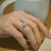 Round cut lab grown diamond halo pavé engagement ring with side stones set in polished gold band