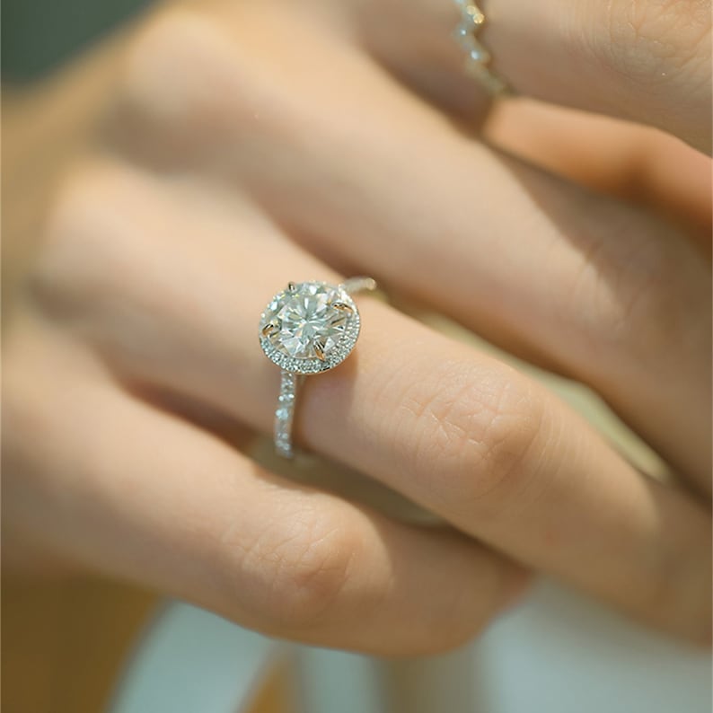 Round cut lab grown diamond halo pavé engagement ring with side stones set in polished gold band