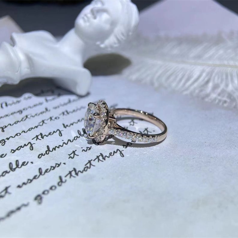 Round cut lab grown diamond halo pavé engagement ring with side stones set in polished gold band