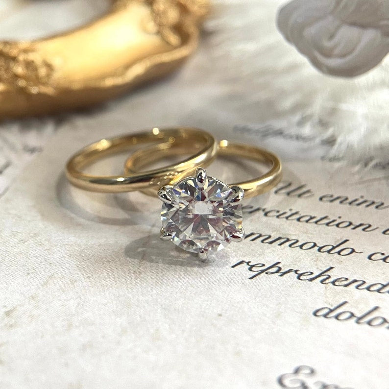 Round cut lab grown diamond solitaire engagement ring, 1.0 to 3.0 carats, set in a prong setting on polished gold band