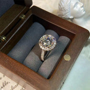 Round cut lab grown diamond halo pavé engagement ring with side stones set in polished gold band