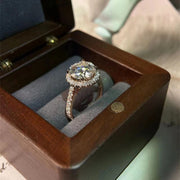 Round cut lab grown diamond halo pavé engagement ring with side stones set in polished gold band