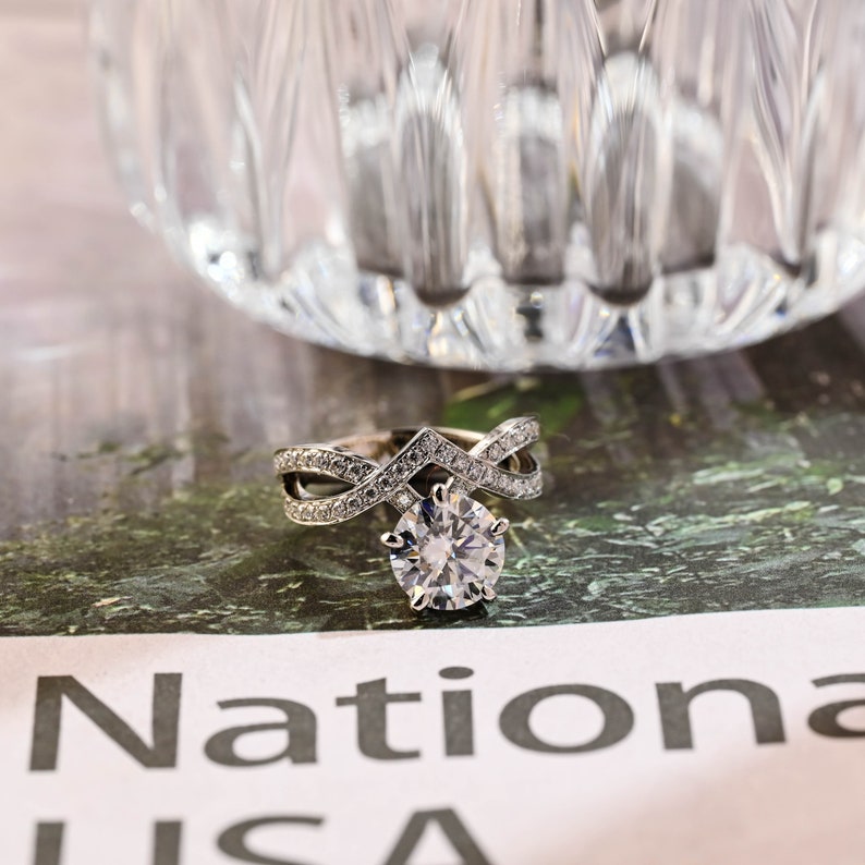 Round cut lab grown diamond engagement ring with unique designer-inspired setting on polished gold band