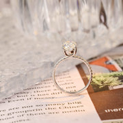 Oval cut lab grown diamond halo pavé engagement ring with side stones, set in prong design on polished gold band