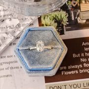 Oval cut lab grown diamond halo pavé engagement ring with side stones, set in prong design on polished gold band