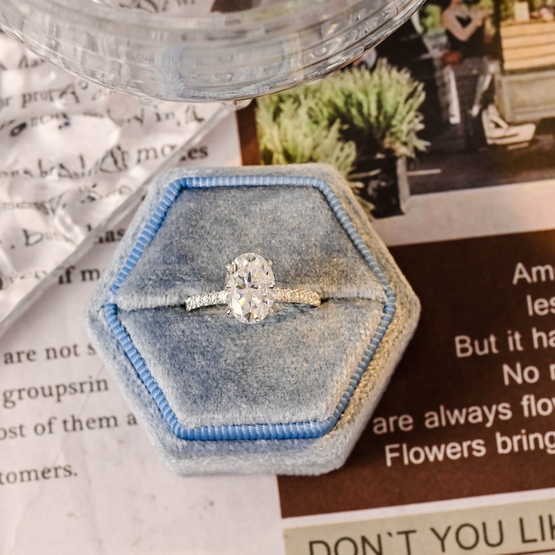 Oval cut lab grown diamond halo pavé engagement ring with side stones, set in prong design on polished gold band