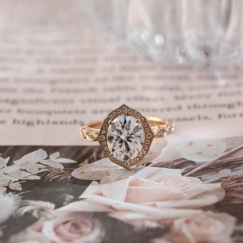 Oval cut lab grown diamond halo pavé engagement ring with prong setting and side stones on polished gold band