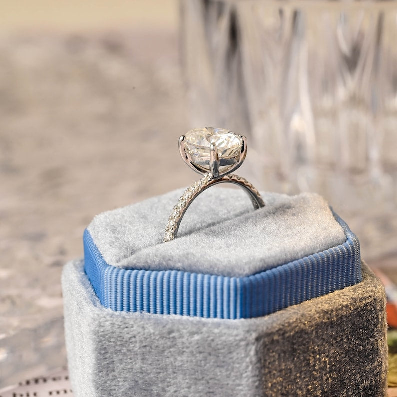 Oval cut lab grown diamond halo pavé engagement ring with side stones, set in prong design on polished gold band