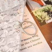 Oval cut lab grown diamond halo pavé engagement ring with side stones, set in prong design on polished gold band