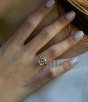 Emerald cut lab grown diamond engagement ring with hidden halo setting, crafted in polished gold for a refined and elegant look