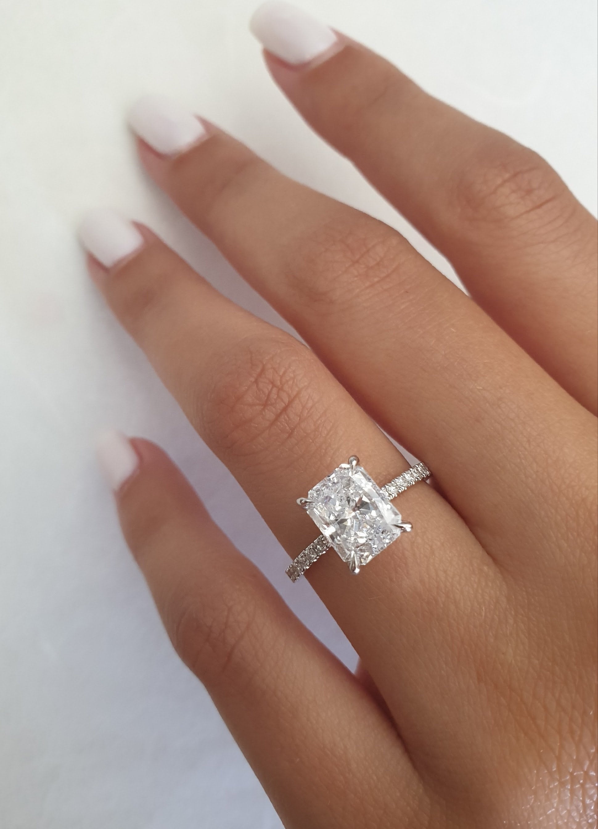 Radiant cut lab grown diamond engagement ring with pavé band in polished gold setting