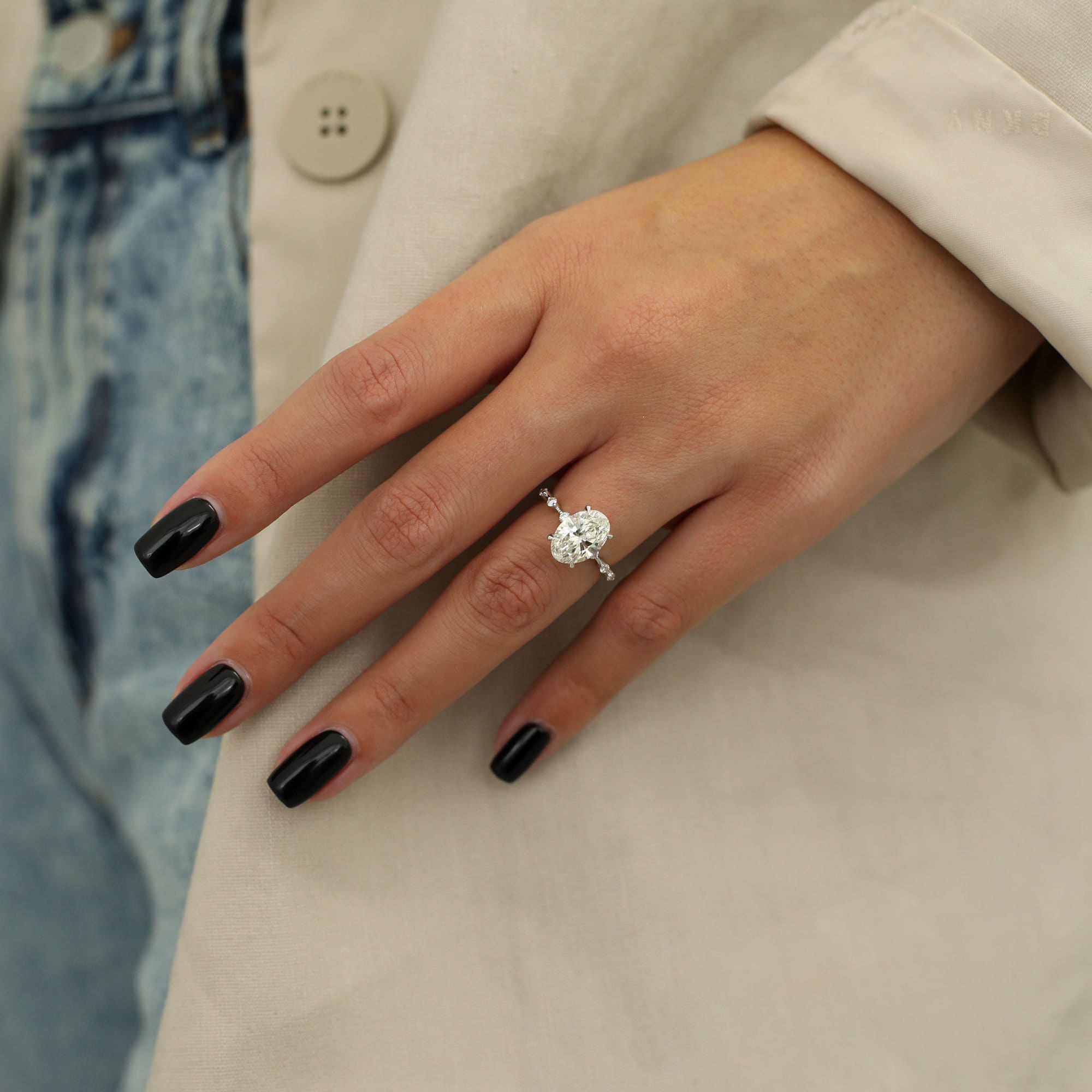 Oval cut lab grown diamond dainty engagement ring in delicate prong setting on slim polished gold band