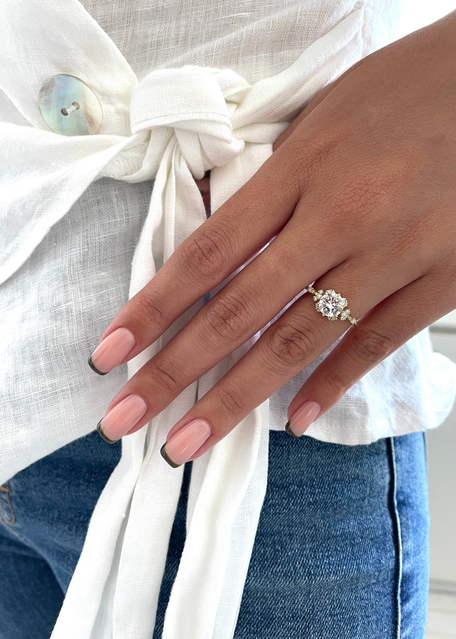 Round cut lab grown diamond dainty style engagement ring with delicate band in polished gold setting