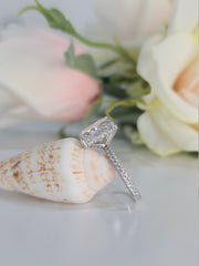 Radiant cut lab grown diamond engagement ring with hidden halo setting on polished gold band, creating extra sparkle and elegance