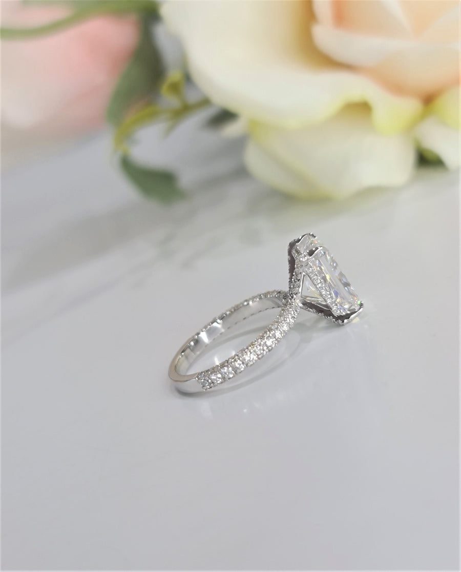 Radiant cut lab grown diamond engagement ring with hidden halo setting on polished gold band, creating extra sparkle and elegance