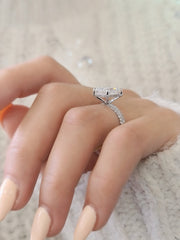 Radiant cut lab grown diamond engagement ring with hidden halo setting on polished gold band, creating extra sparkle and elegance