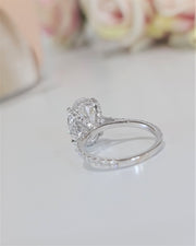 Oval cut lab grown diamond hidden halo engagement ring with delicate pavé accents set in polished gold band