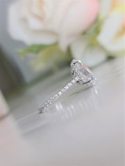 Oval cut lab grown diamond hidden halo engagement ring with delicate pavé accents set in polished gold band
