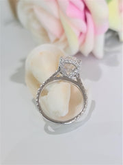 Oval cut lab grown diamond hidden halo engagement ring with delicate pavé accents set in polished gold band