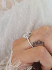 Oval cut lab grown diamond hidden halo engagement ring with delicate pavé accents set in polished gold band