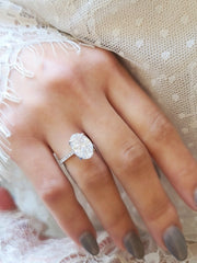 Oval cut lab grown diamond hidden halo engagement ring with delicate pavé accents set in polished gold band