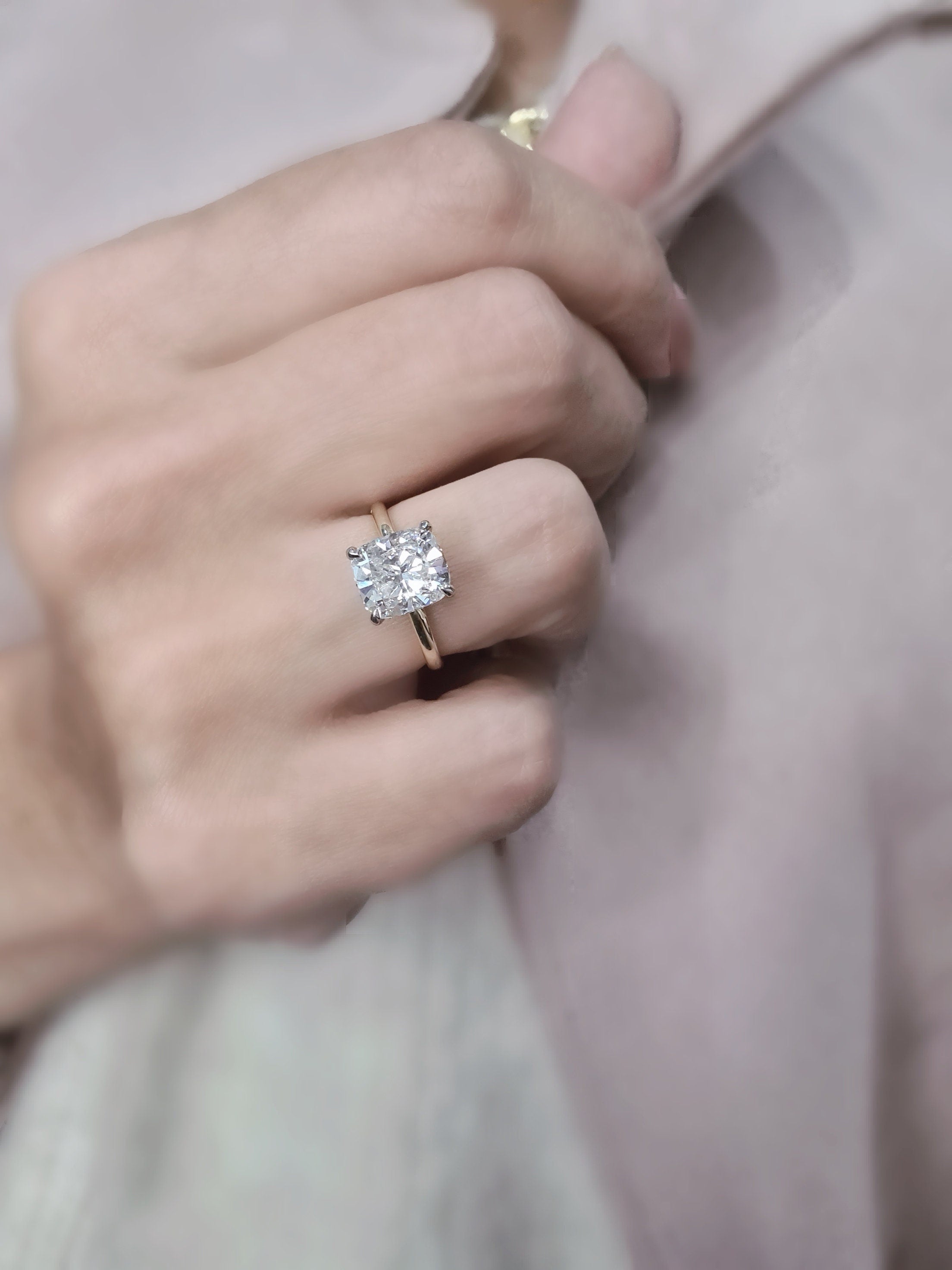 Cushion cut lab grown diamond engagement ring with hidden halo setting, featuring prong design on polished gold band