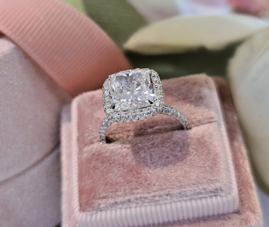 Cushion cut lab grown diamond double halo engagement ring with pavé accents set in polished gold band