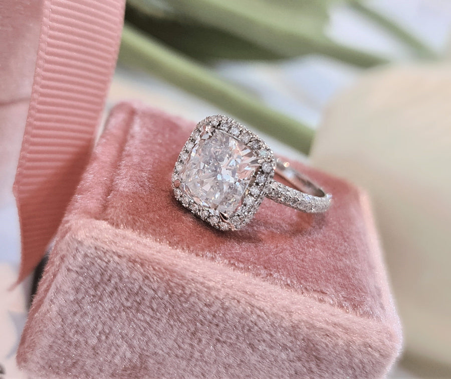 Cushion cut lab grown diamond double halo engagement ring with pavé accents set in polished gold band