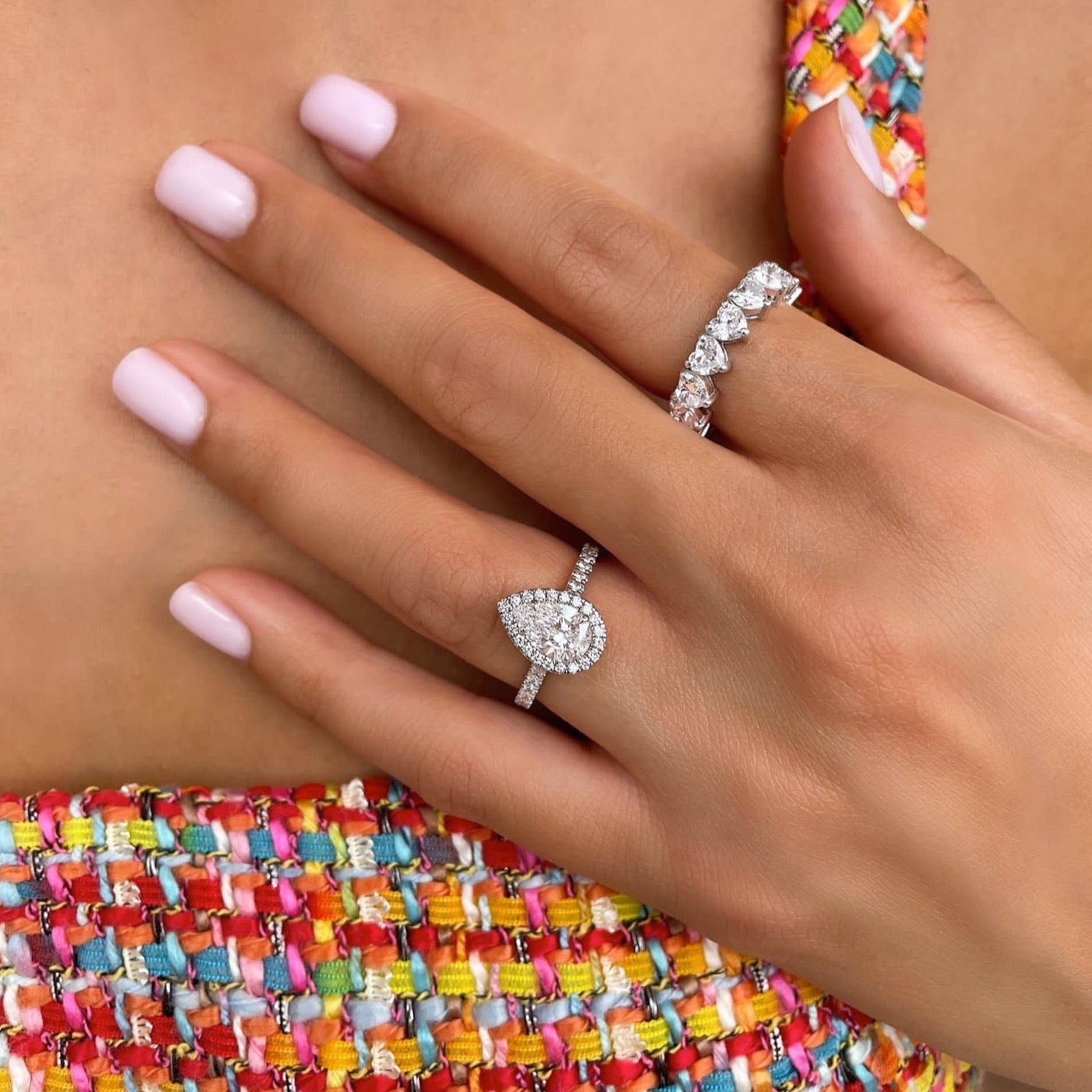 Pear cut lab grown diamond halo and pavé engagement ring with prong-set center stone and side accents on polished gold band